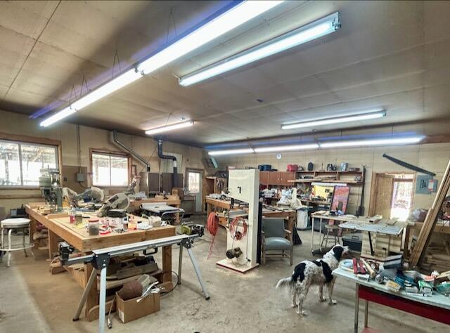 2165 E Cherry Creek Rd, Fairview, MI 48621 - misc room with a workshop area and concrete flooring