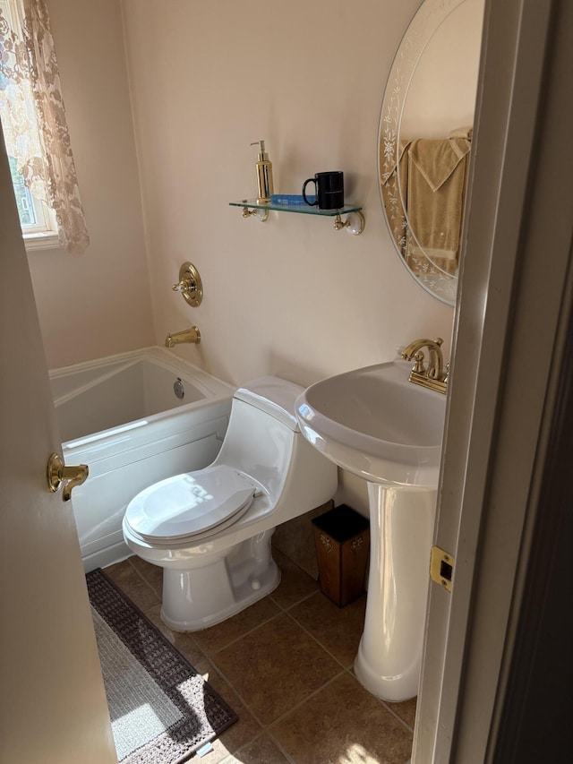 full bath featuring tile patterned floors, a bathtub, and toilet