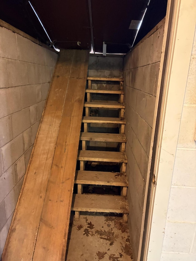 stairs with concrete block wall