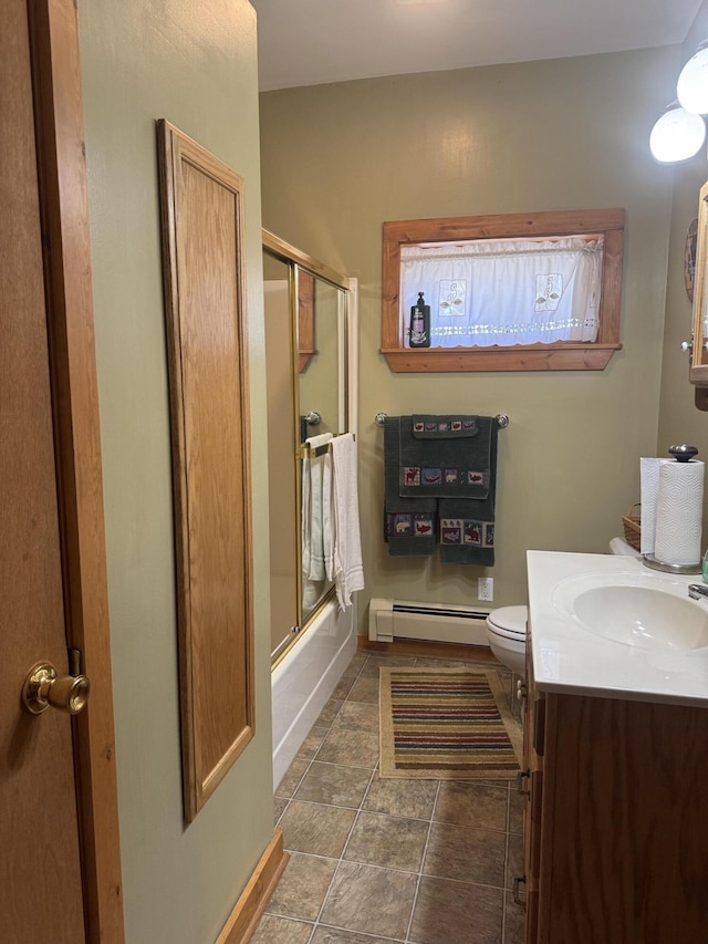 full bath with baseboard heating, vanity, toilet, combined bath / shower with glass door, and baseboards