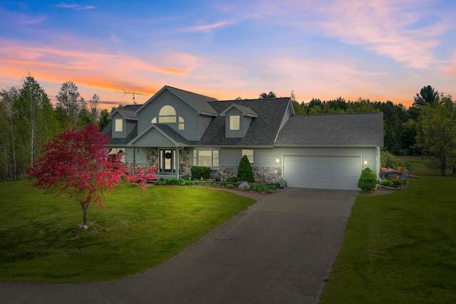 201 Country Ct, Houghton Lake, MI 48629 - view of front of property featuring stone siding, an attached garage, covered porch, driveway, and a front lawn
