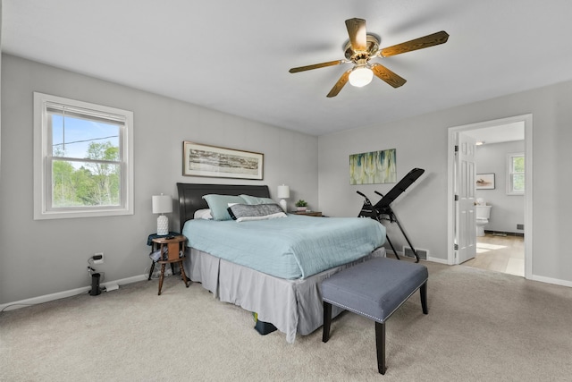 201 Country Ct, Houghton Lake, MI 48629 - bedroom featuring carpet flooring, baseboards, ensuite bathroom, and ceiling fan