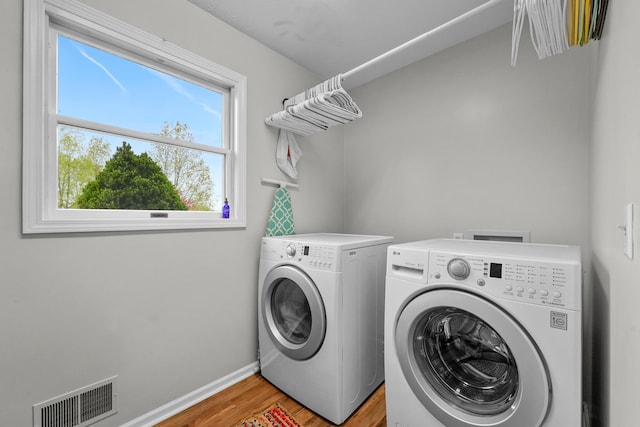 201 Country Ct, Houghton Lake, MI 48629 - laundry room with washing machine and clothes dryer, light wood-style flooring, and baseboards