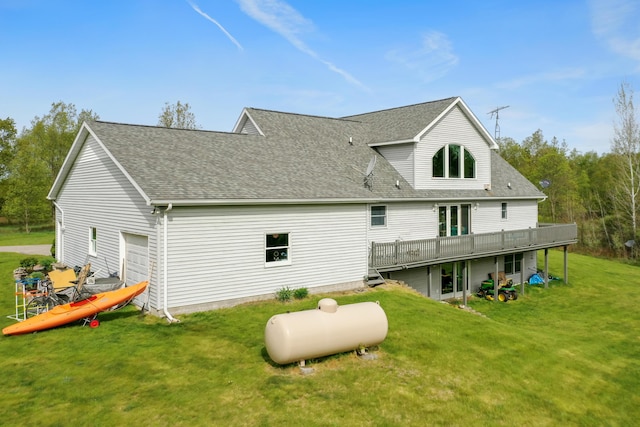 201 Country Ct, Houghton Lake, MI 48629 - rear view of property featuring a wooden deck, a lawn, a shingled roof, and an attached garage