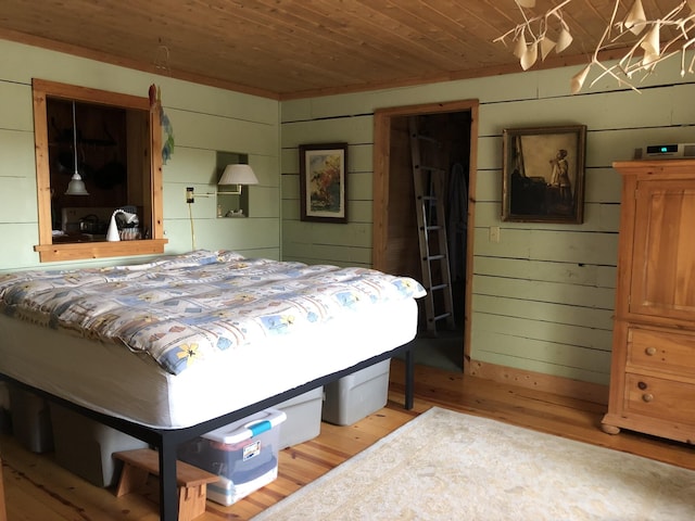 4550 E Simmons Rd, Hessel, MI 49745 - bedroom with light wood-style flooring and wooden ceiling