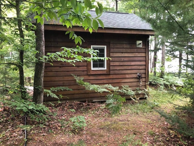4550 E Simmons Rd, Hessel, MI 49745 - view of side of home featuring roof with shingles and an outdoor structure