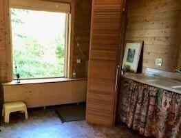 4550 E Simmons Rd, Hessel, MI 49745 - doorway with wood walls