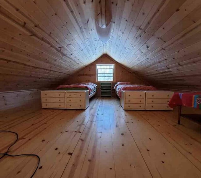 4550 E Simmons Rd, Hessel, MI 49745 - unfurnished bedroom featuring vaulted ceiling, wood-type flooring, wood ceiling, and wooden walls