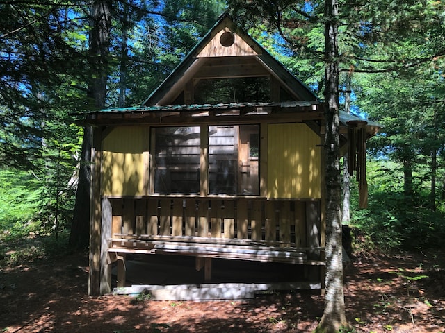 4550 E Simmons Rd, Hessel, MI 49745 - back of house featuring metal roof