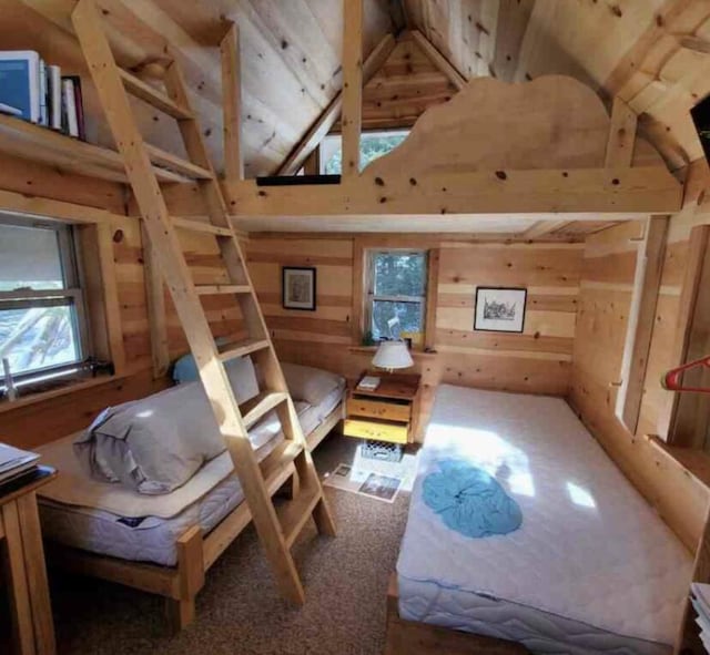 4550 E Simmons Rd, Hessel, MI 49745 - bedroom with high vaulted ceiling, wood walls, and wooden ceiling