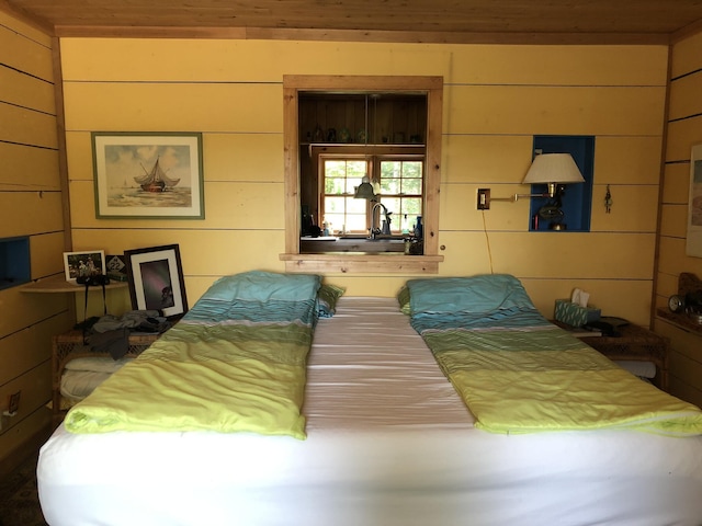 4550 E Simmons Rd, Hessel, MI 49745 - bedroom with wood walls