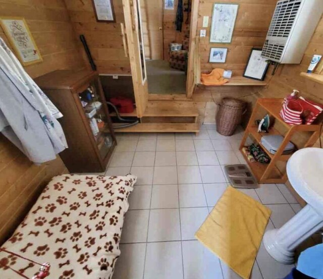 4550 E Simmons Rd, Hessel, MI 49745 - bathroom featuring wooden walls and tile patterned floors