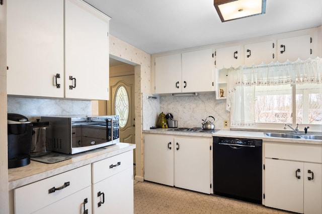 7654 M 32 E, Johannesburg, MI 49751 - kitchen featuring a sink, black dishwasher, decorative backsplash, light countertops, and stainless steel stovetop