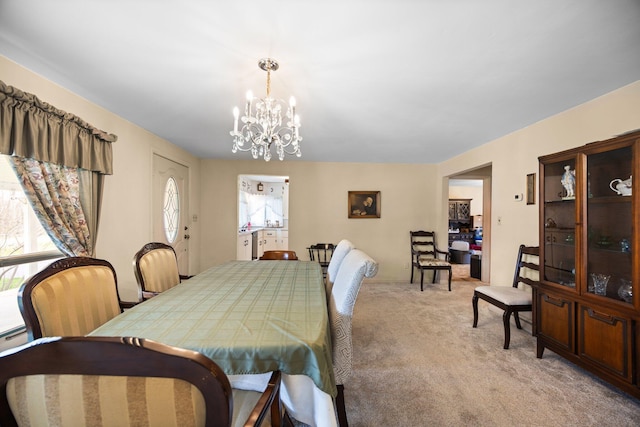7654 M 32 E, Johannesburg, MI 49751 - dining space featuring a chandelier and light colored carpet
