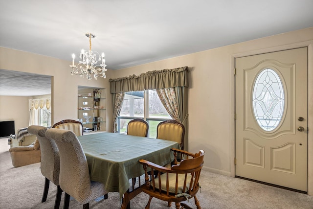7654 M 32 E, Johannesburg, MI 49751 - dining space with carpet floors, a chandelier, plenty of natural light, and baseboards
