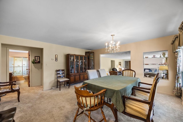 7654 M 32 E, Johannesburg, MI 49751 - dining area with a chandelier, light colored carpet, and baseboards