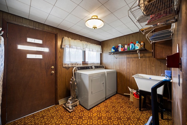 7654 M 32 E, Johannesburg, MI 49751 - laundry area featuring washer and clothes dryer, wood walls, and tile patterned floors