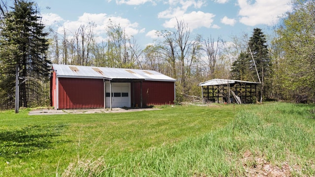 7654 M 32 E, Johannesburg, MI 49751 - view of green lawn with a pole building, a garage, and an outbuilding