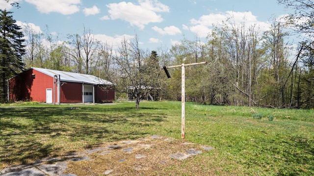 7654 M 32 E, Johannesburg, MI 49751 - view of grassy yard featuring an outbuilding and a garage