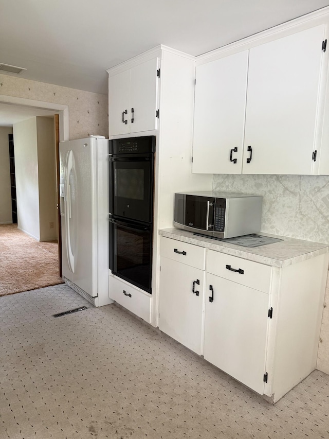 7654 M 32 E, Johannesburg, MI 49751 - kitchen featuring white fridge with ice dispenser, stainless steel microwave, light countertops, and white cabinetry