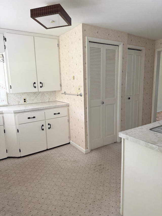 7654 M 32 E, Johannesburg, MI 49751 - kitchen featuring white cabinets, light countertops, and baseboards