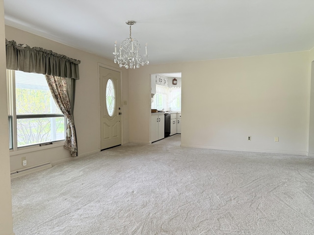 7654 M 32 E, Johannesburg, MI 49751 - foyer entrance with a chandelier, light carpet, a baseboard heating unit, and baseboards
