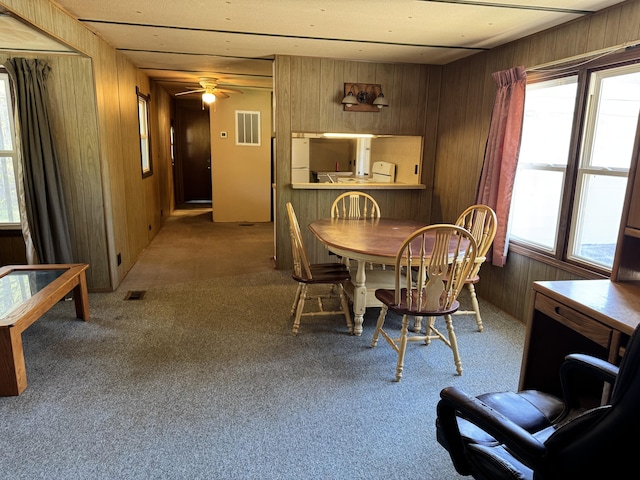 1321 Eagle Point Rd, Grayling, MI 49738 - dining area featuring wooden walls, carpet flooring, and a ceiling fan