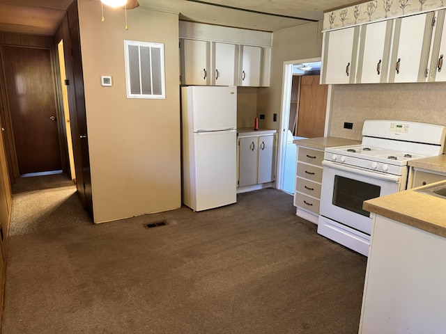 1321 Eagle Point Rd, Grayling, MI 49738 - kitchen with white appliances, dark colored carpet, white cabinetry, and light countertops