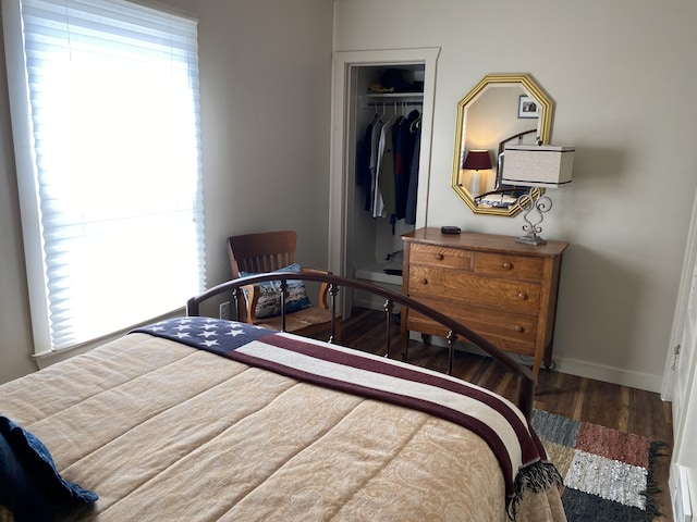 737 S First St, Rogers City, MI 49779 - bedroom featuring wood finished floors, baseboards, and a closet