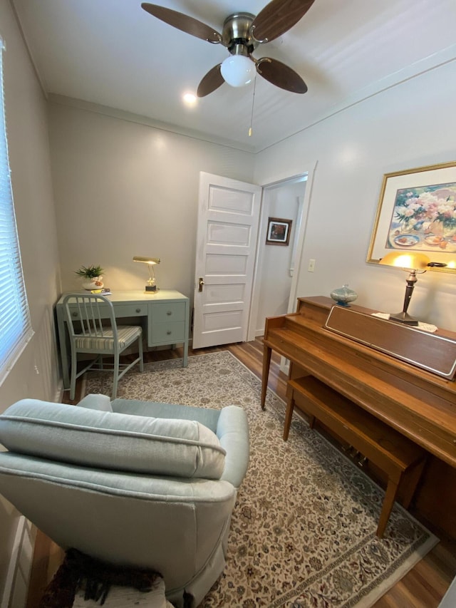 737 S First St, Rogers City, MI 49779 - living area featuring wood finished floors, ceiling fan, and baseboards