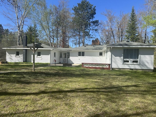 1371 Wayne Rd, Alpena, MI 49707 - back of property featuring a chimney and a lawn
