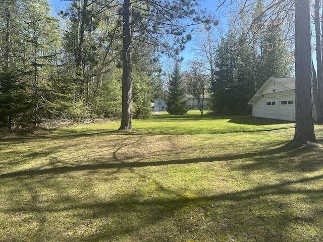 1371 Wayne Rd, Alpena, MI 49707 - view of grassy yard featuring a garage