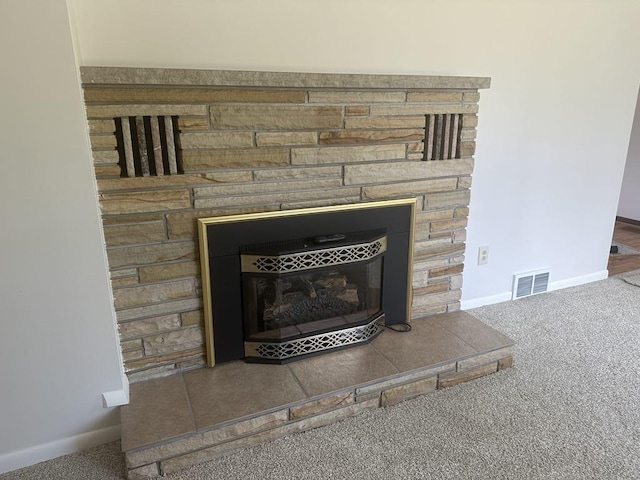 1371 Wayne Rd, Alpena, MI 49707 - detailed view of a stone fireplace, carpet, and baseboards