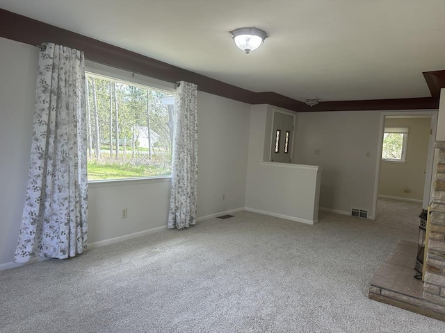 1371 Wayne Rd, Alpena, MI 49707 - unfurnished living room featuring carpet and baseboards