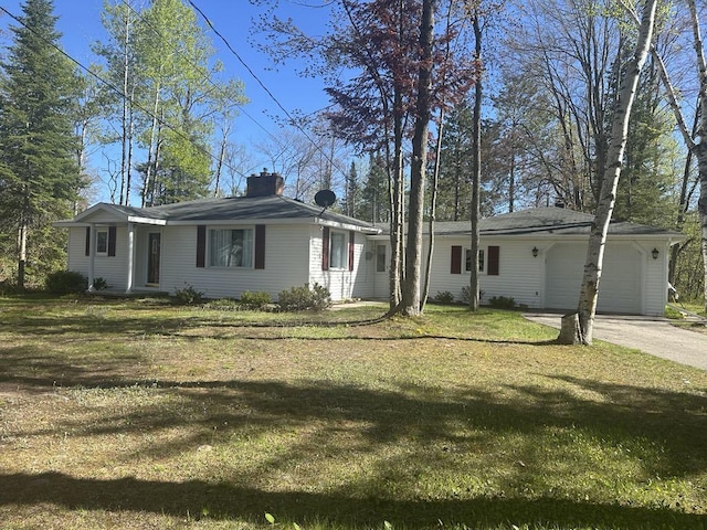 1371 Wayne Rd, Alpena, MI 49707 - view of front of home with a garage, a chimney, driveway, and a front yard