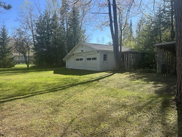 1371 Wayne Rd, Alpena, MI 49707 - view of green lawn with a detached garage and an outbuilding