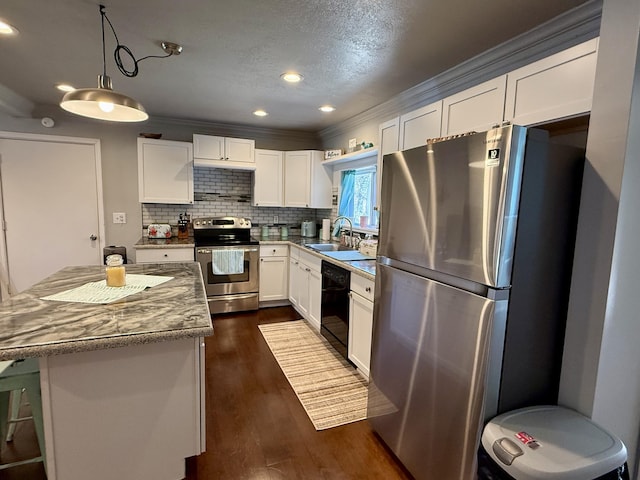 1073 S Hoot Owl Ln, Grayling, MI 49738 - kitchen featuring appliances with stainless steel finishes, a sink, white cabinetry, dark wood-style floors, and ornamental molding