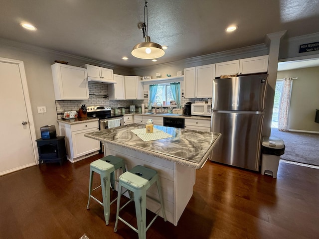 1073 S Hoot Owl Ln, Grayling, MI 49738 - kitchen featuring appliances with stainless steel finishes, ornamental molding, white cabinetry, a sink, and backsplash