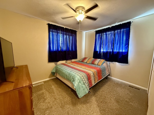1073 S Hoot Owl Ln, Grayling, MI 49738 - bedroom with carpet floors, a textured ceiling, baseboards, and ceiling fan