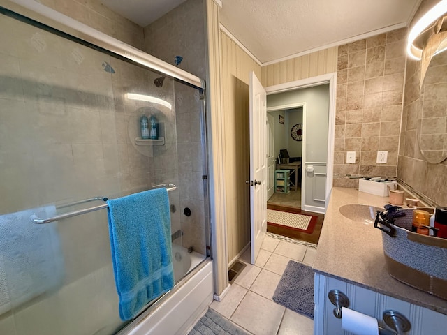 1073 S Hoot Owl Ln, Grayling, MI 49738 - bathroom with tile patterned floors, shower / bath combination with glass door, vanity, and ornamental molding