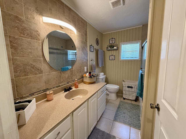 1073 S Hoot Owl Ln, Grayling, MI 49738 - bathroom featuring tile patterned floors, toilet, vanity, a shower, and crown molding