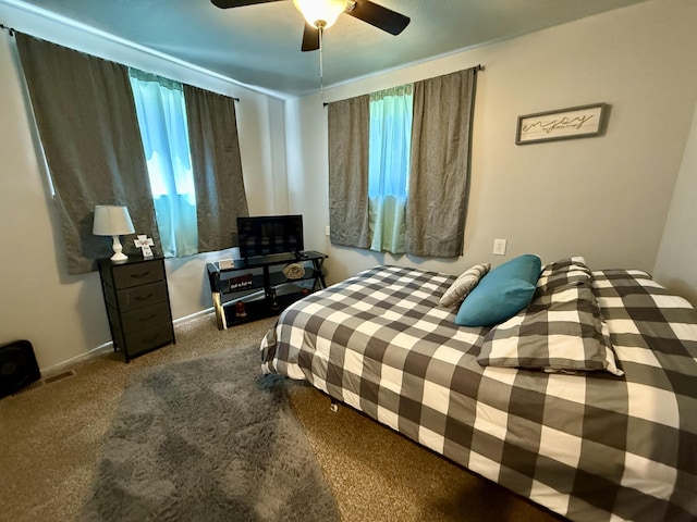 1073 S Hoot Owl Ln, Grayling, MI 49738 - carpeted bedroom featuring a ceiling fan and baseboards