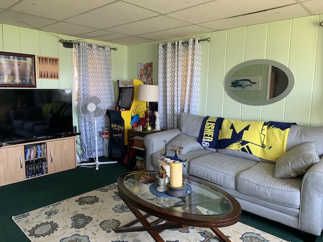 carpeted living room with a paneled ceiling and a decorative wall