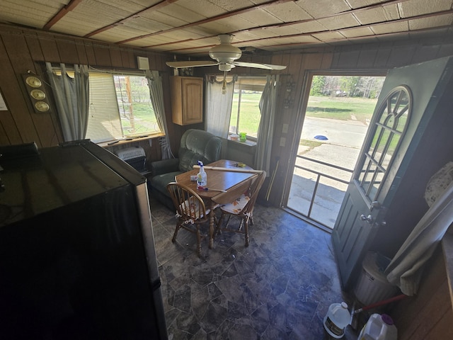3625 Mckinley Rd, Mio, MI 48647 - dining area with wooden walls, ceiling fan, and healthy amount of natural light
