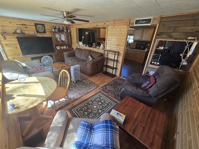 3625 Mckinley Rd, Mio, MI 48647 - living room with wooden walls, wood finished floors, and ceiling fan