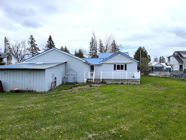 615 Duncan Ave, Cheboygan, MI 49721 - back of house featuring a deck, metal roof, and board and batten siding