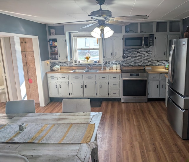615 Duncan Ave, Cheboygan, MI 49721 - kitchen with stainless steel appliances, a ceiling fan, dark wood finished floors, open shelves, and a sink