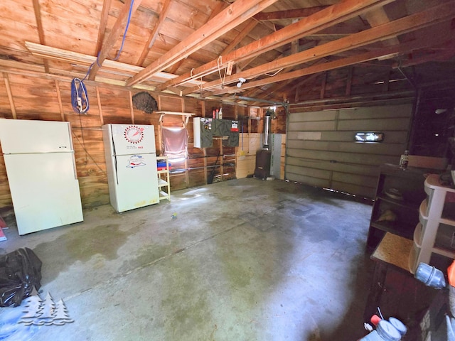 4097 Sunset Dr, Lewiston, MI 49756 - garage featuring freestanding refrigerator