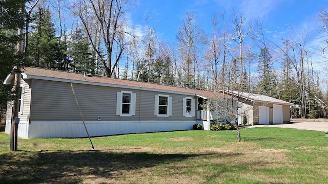 10340 US-23, Cheboygan, MI 49721 - manufactured / mobile home with a garage and a front yard