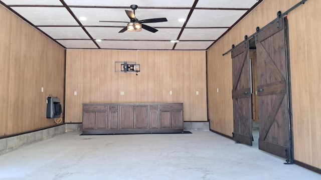 10340 US-23, Cheboygan, MI 49721 - interior space featuring concrete flooring, a barn door, and ceiling fan